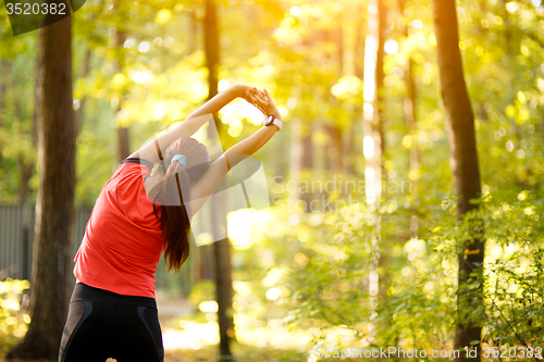 Image of woman exercising in park