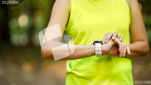 Image of Close up image of woman checking time