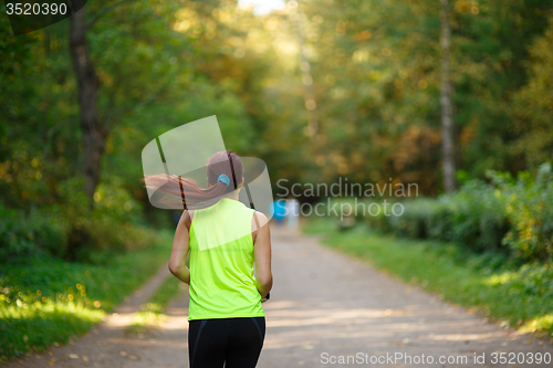 Image of woman running at forest