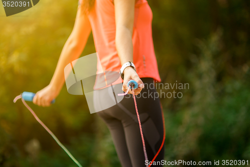 Image of Close up of woman feet jumping in skipping rope