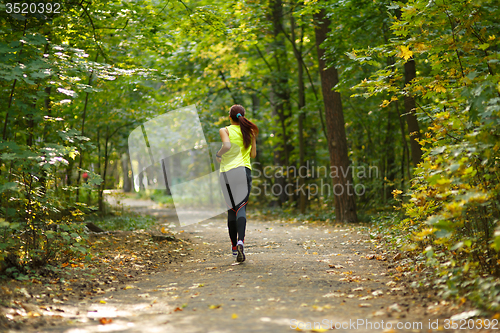 Image of woman running at forest