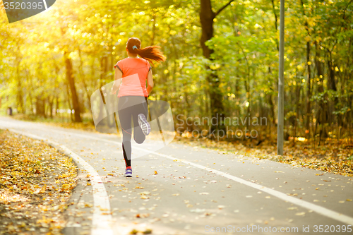 Image of woman running in park