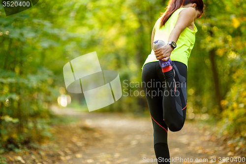 Image of woman exercising and stretching muscles 