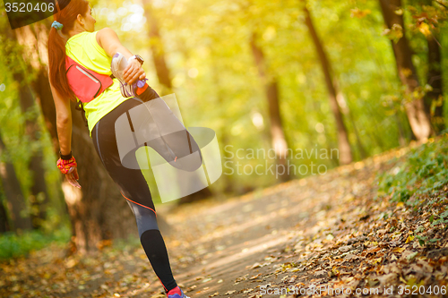 Image of woman exercising and stretching muscles 
