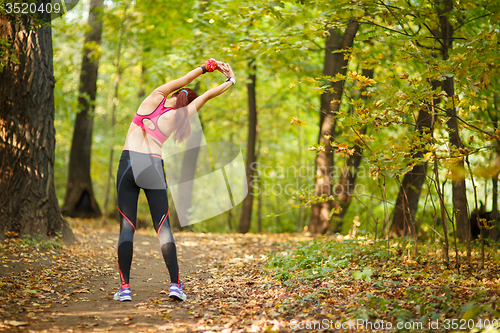 Image of woman exercising before jogging 