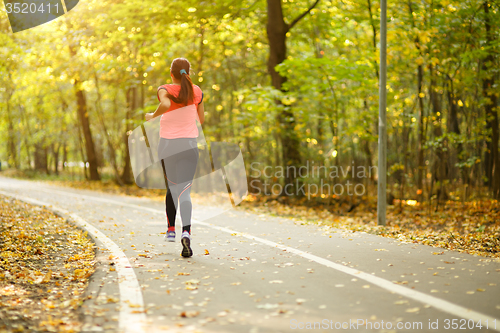 Image of woman running in park