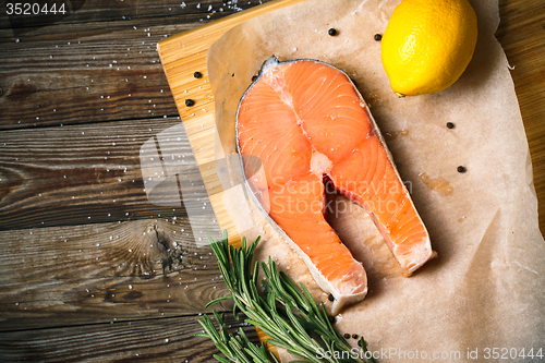 Image of fresh salmon fillet with herbs, spices and lemon
