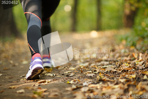 Image of Runner feet running on road