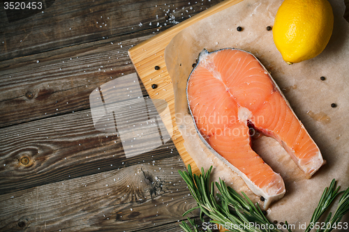 Image of fresh salmon fillet with herbs, spices and lemon