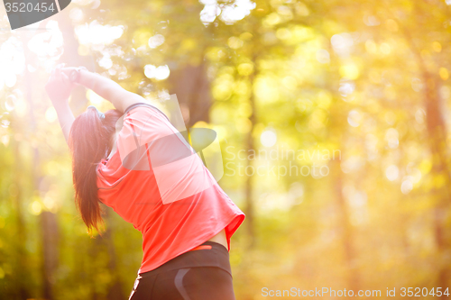 Image of woman exercising in park