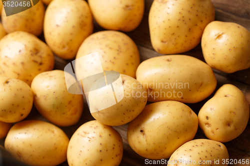 Image of potatoes on wooden background