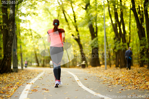 Image of woman running in park