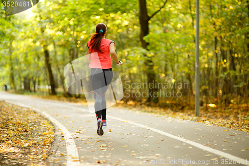 Image of woman running in park