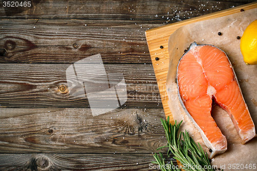 Image of fresh salmon fillet with herbs, spices and lemon