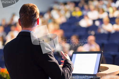 Image of Speaker at Business Conference and Presentation.