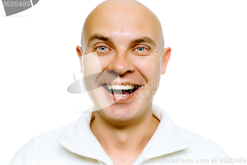 Image of Bald smiling blue-eyed man. Studio. isolated