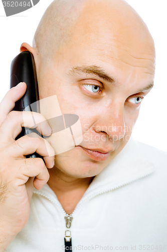Image of Bald, blue-eyed man with a telephone. Studio. isolated