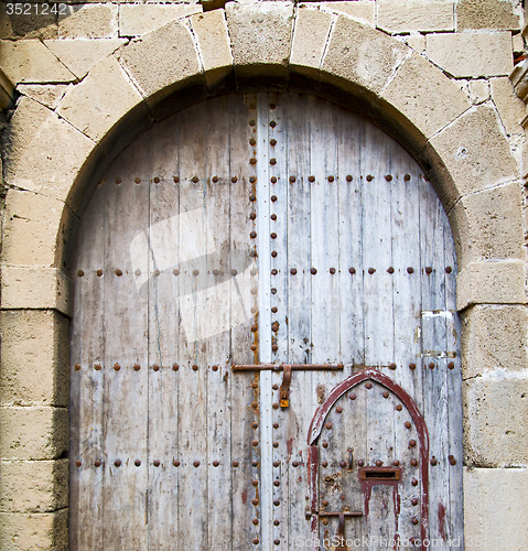 Image of antique door in morocco africa blue wood and metal rusty