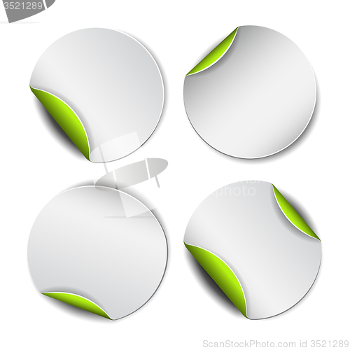 Image of Set of white round stickers with green backside.