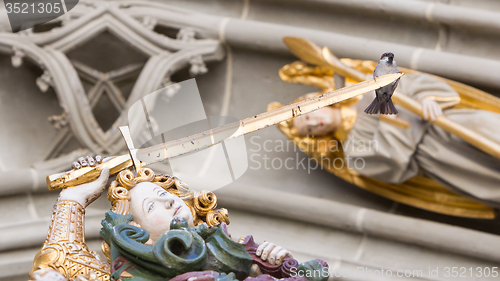 Image of Berner Muenster, sparrow sitting on a sword