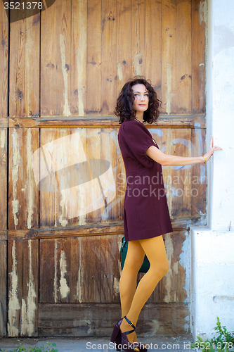 Image of beautiful woman in a burgundy dress