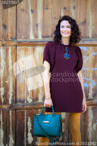 Image of beautiful middle-aged woman in a burgundy dress