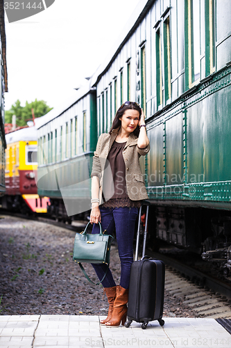 Image of beautiful middle-aged woman with luggage