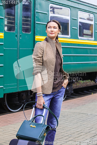 Image of woman with luggage returned from a retro travel