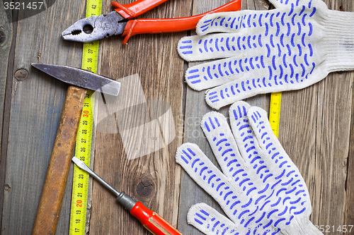 Image of old locksmith tools, work gloves and measuring tape