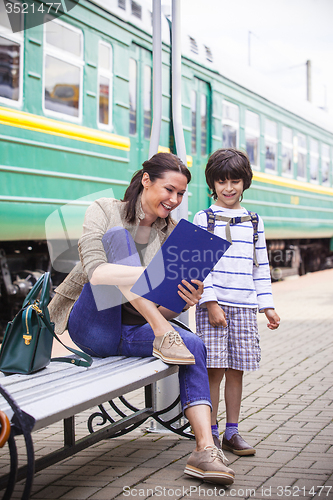 Image of mother and son waiting for a train