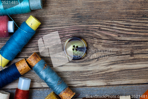 Image of old button and spools with threads