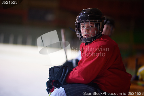 Image of children ice hockey players on bench