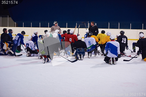 Image of ice hockey players team meeting with trainer