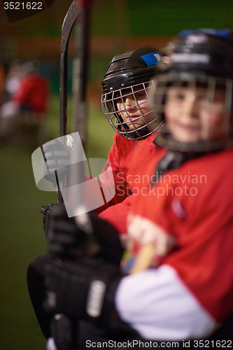 Image of children ice hockey players on bench