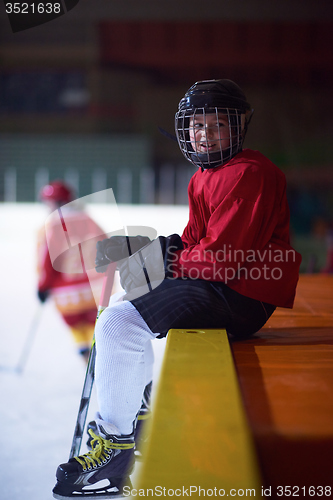 Image of children ice hockey players on bench