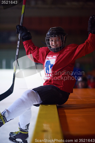 Image of children ice hockey players on bench