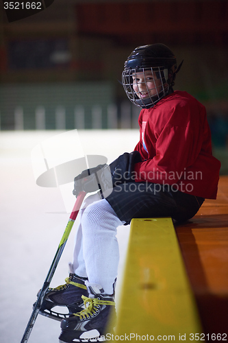 Image of children ice hockey players on bench