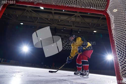 Image of teen ice hockey player in action