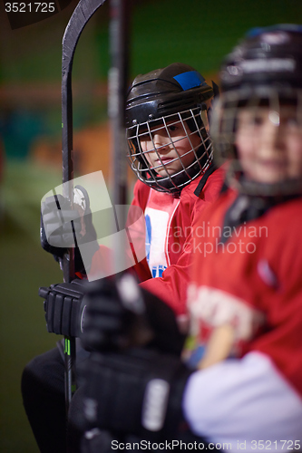 Image of children ice hockey players on bench