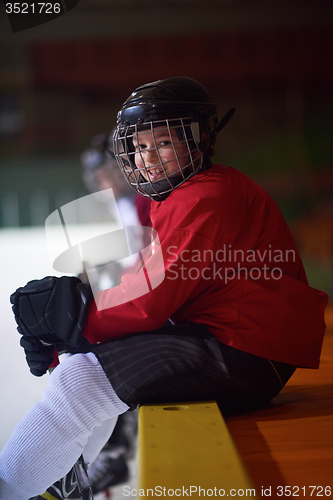 Image of children ice hockey players on bench