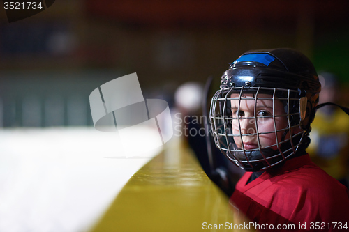 Image of children ice hockey players on bench