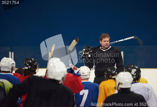 Image of ice hockey players team meeting with trainer