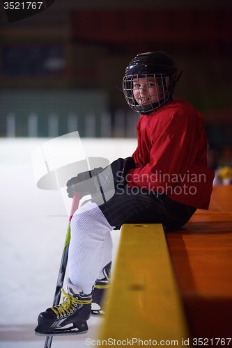 Image of children ice hockey players on bench