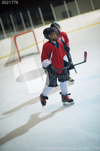 Image of children ice hockey players on bench