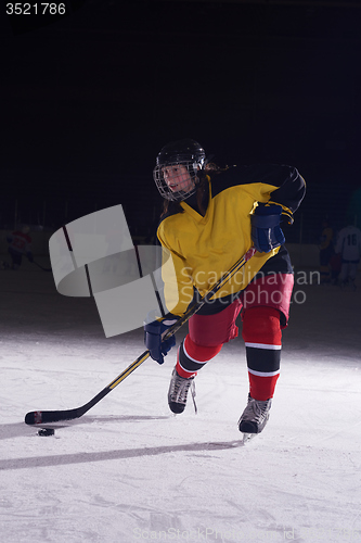 Image of teen ice hockey player in action