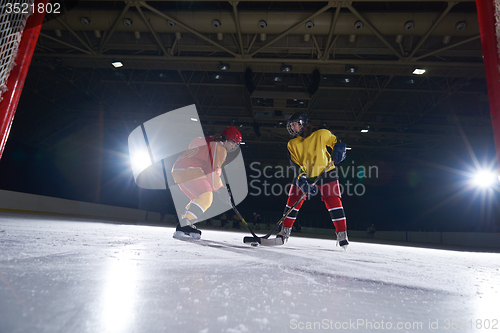 Image of teen ice hockey sport  players in action