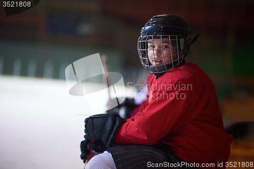 Image of children ice hockey players on bench