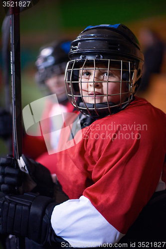 Image of children ice hockey players on bench