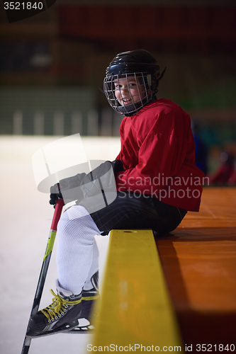 Image of children ice hockey players on bench