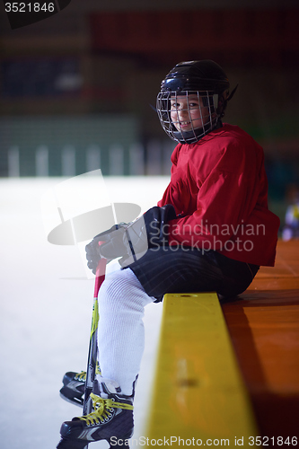 Image of children ice hockey players on bench